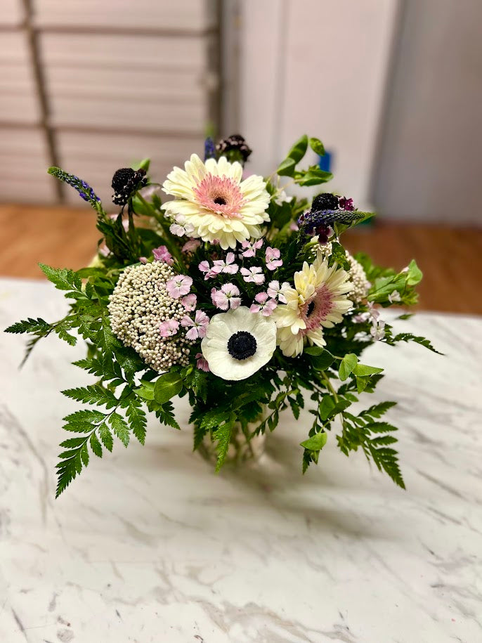 Pink lilies, red roses, and lavender hydrangea with eucalyptus