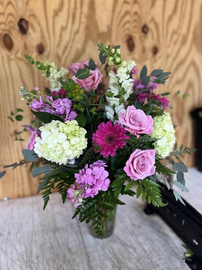Sunflowers and yellow roses with purple alstroemeria and green hydrangea